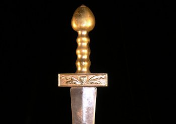 Evocative of an ancient world sword with classic brass hilt