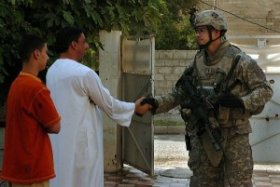 soldier shaking hands with an Iraqi